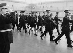 Commissioner Graham saluting the first class to include women as uniform members, 1974 (2008.35.8)